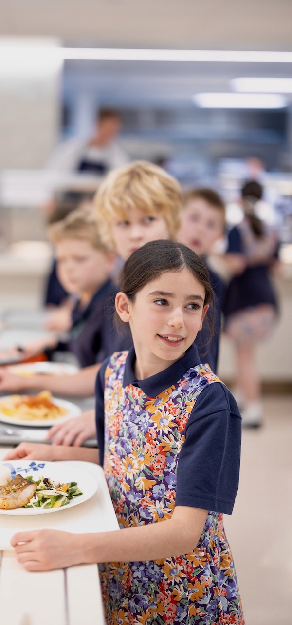 Prep pupil in the Great Hall of Ibstock Place School getting their lunch.