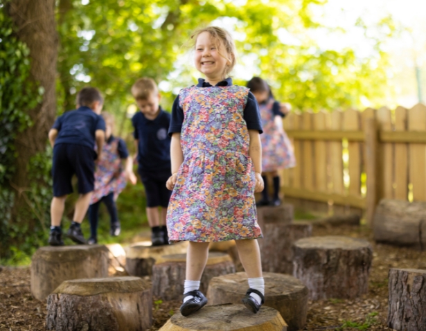 Prep pupil playing at Ibstock Place School's forest school