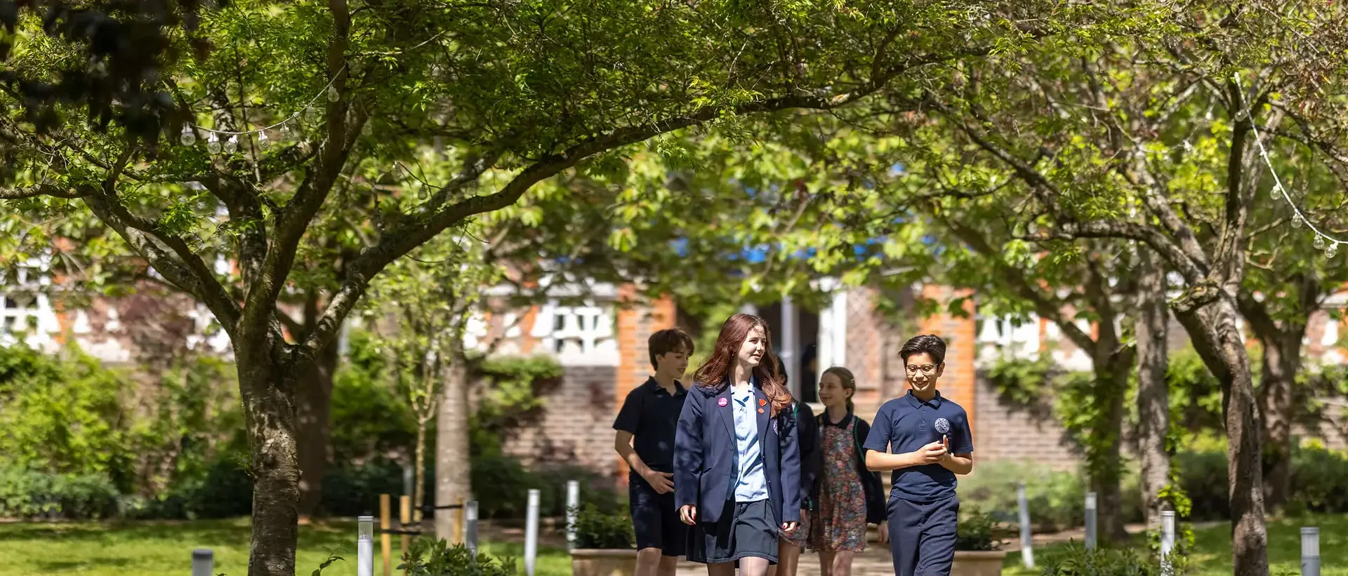 Pupils walking in the school grounds at Ibstock Place School