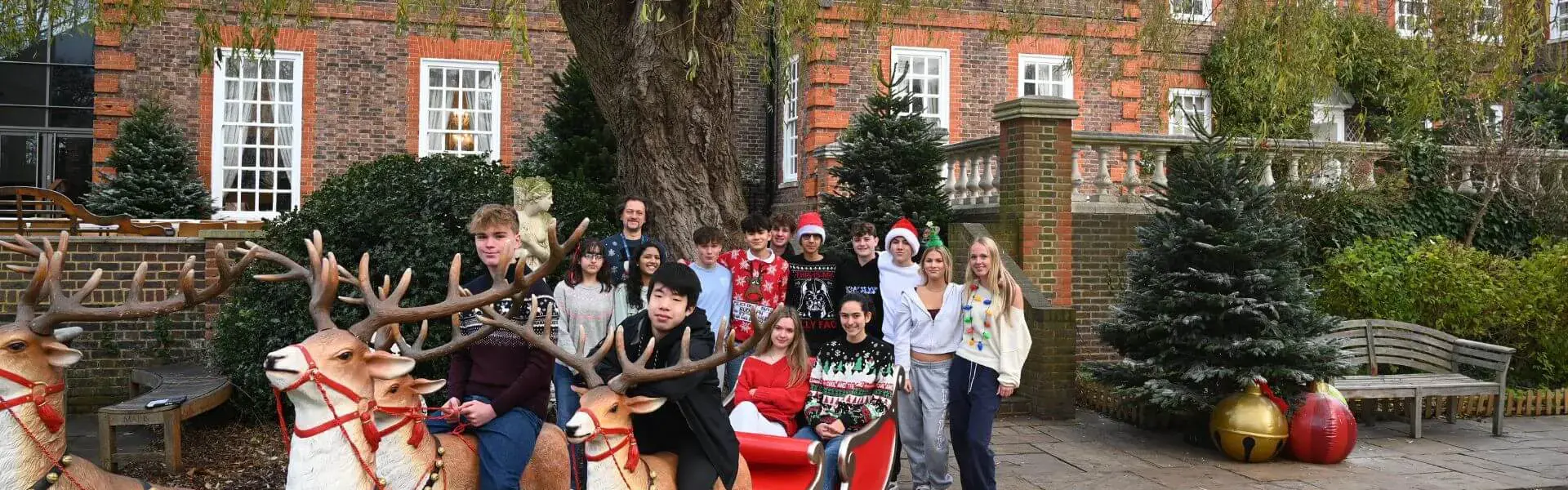 Senior pupils sitting on a sleigh | Ibstock Place School, Roehampton, Private School Near Richmond, Barnes, Putney, Kingston, & Wandsworth 