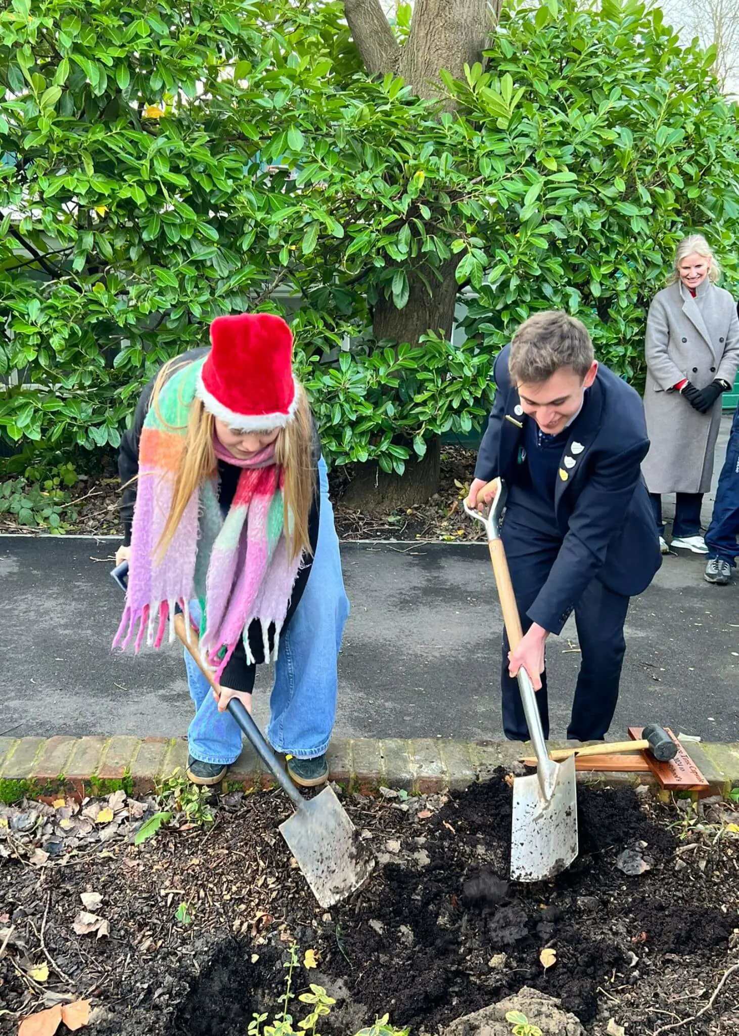 Senior pupils burying a time capsule | Ibstock Place School, Roehampton, Private School Near Richmond, Barnes, Putney, Kingston, & Wandsworth 