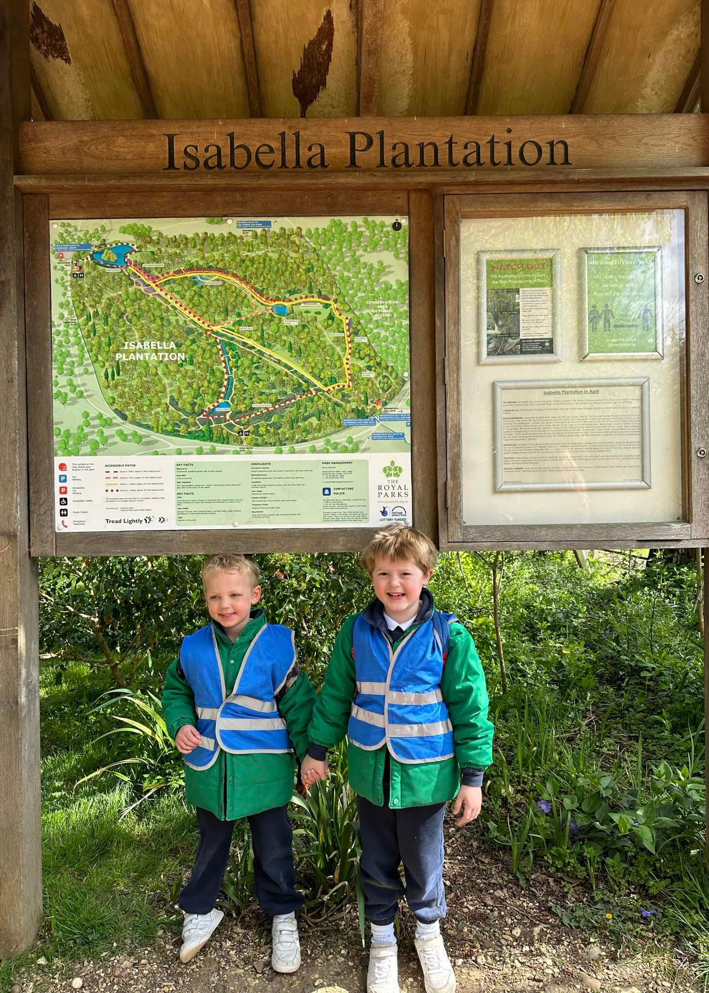 Photo of a Kindergarten pupil in front of Isabella plantation sign| Ibstock Place School, a private school near Richmond, Barnes, Putney, Kingston, and Wandsworth.