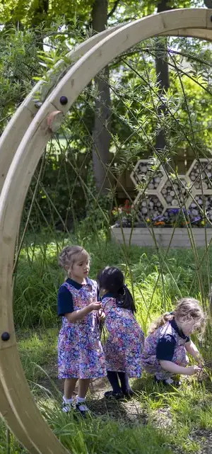 Prep pupils playing in the forest school of  Ibstock Place School, a private school near Richmond, Barnes, Wandsworth.