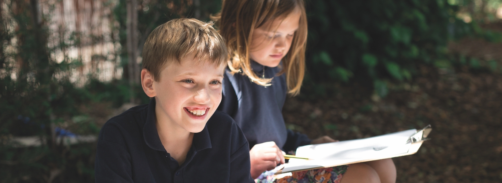 prep pupils playing in the forest school of Ibstock Place School, a private school near Richmond.