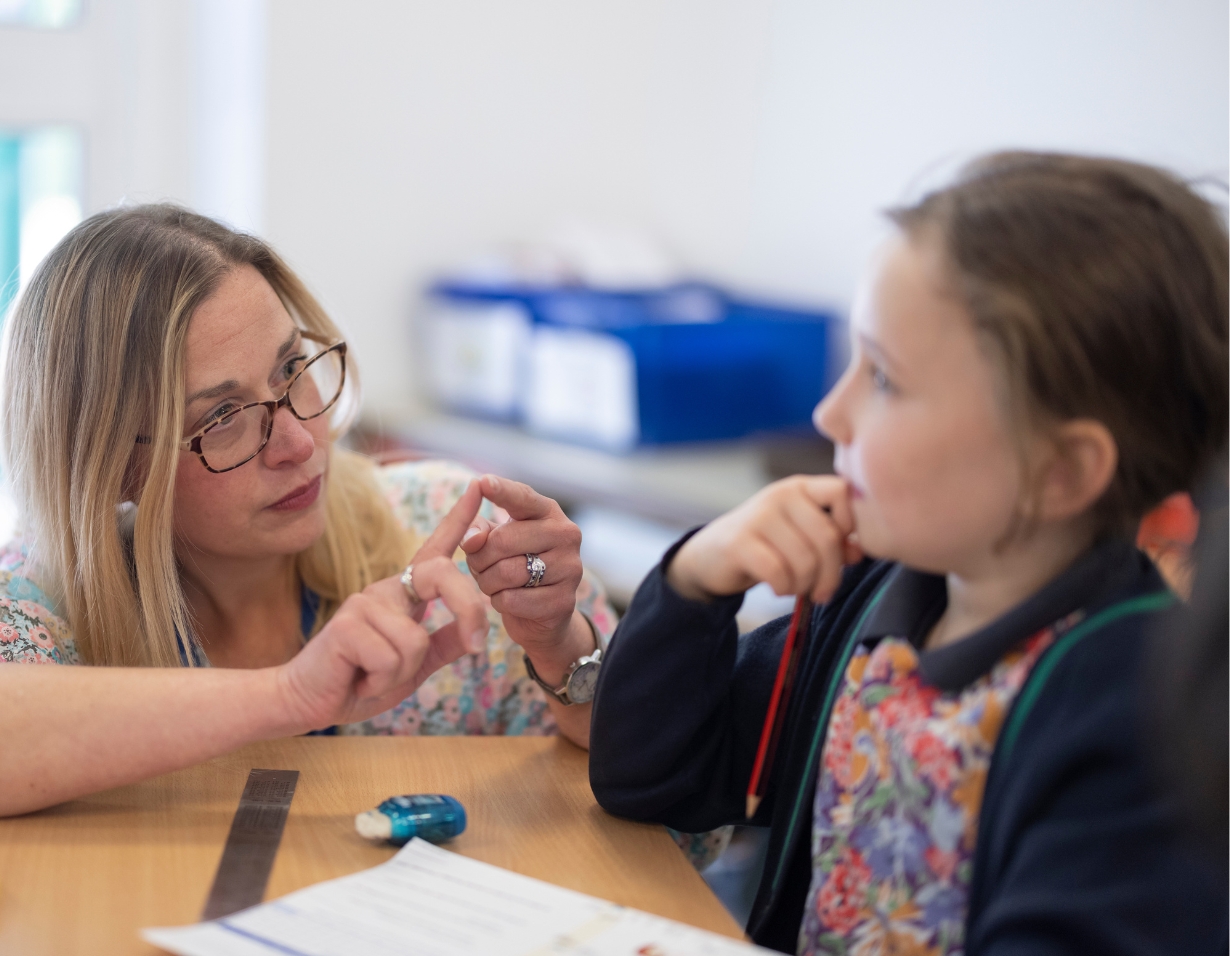 A teacher is explaining a lesson to a prep pupil of Ibstock Place School, a private school near Richmond.