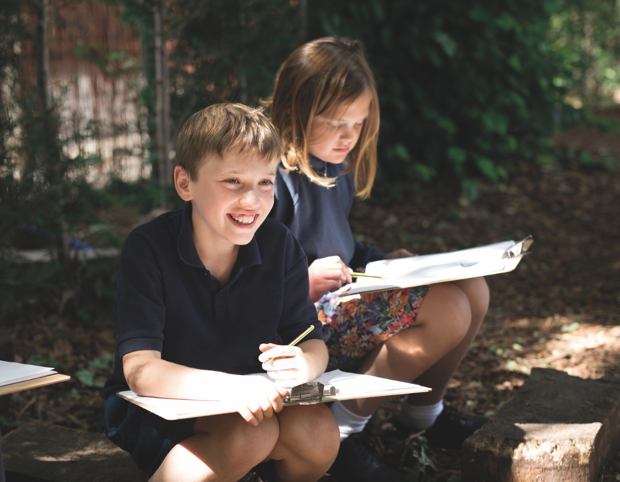 Prep pupils studying in the nature at the forest school of at Ibstock Place School, a private school near Richmond