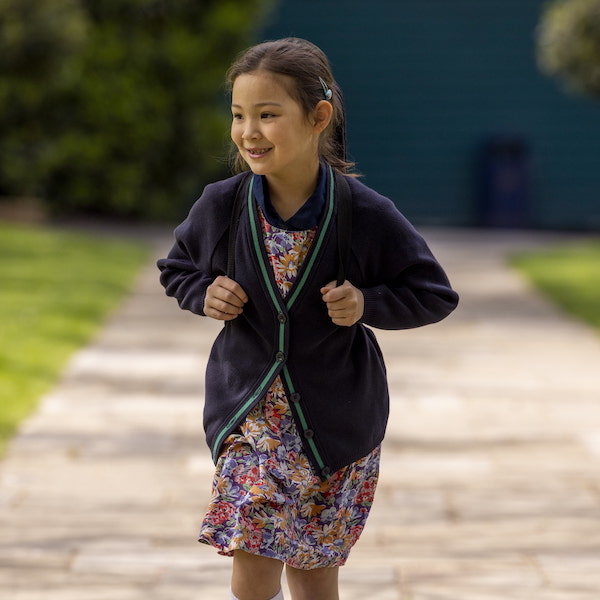 Prep pupil with a backpack in the playground of Ibstock Place School, a private school near Richmond.