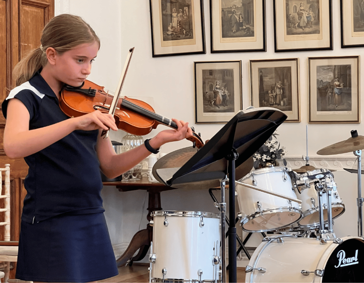 Prep pupil performing a musical instrument at Ibstock Place School, a private school near Richmond.