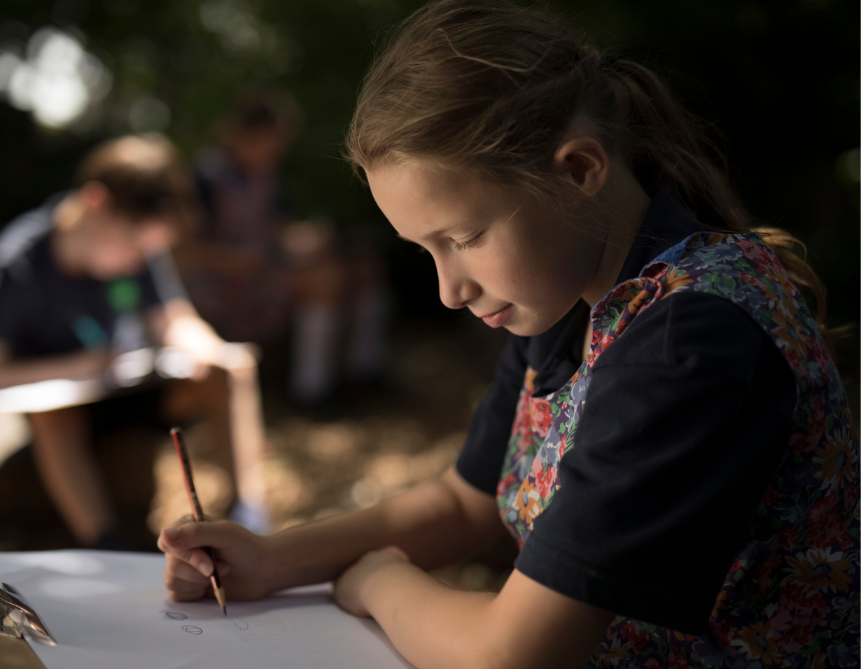 Prep pupils studying in the nature in the campus at Ibstock Place School, a private school near Richmond