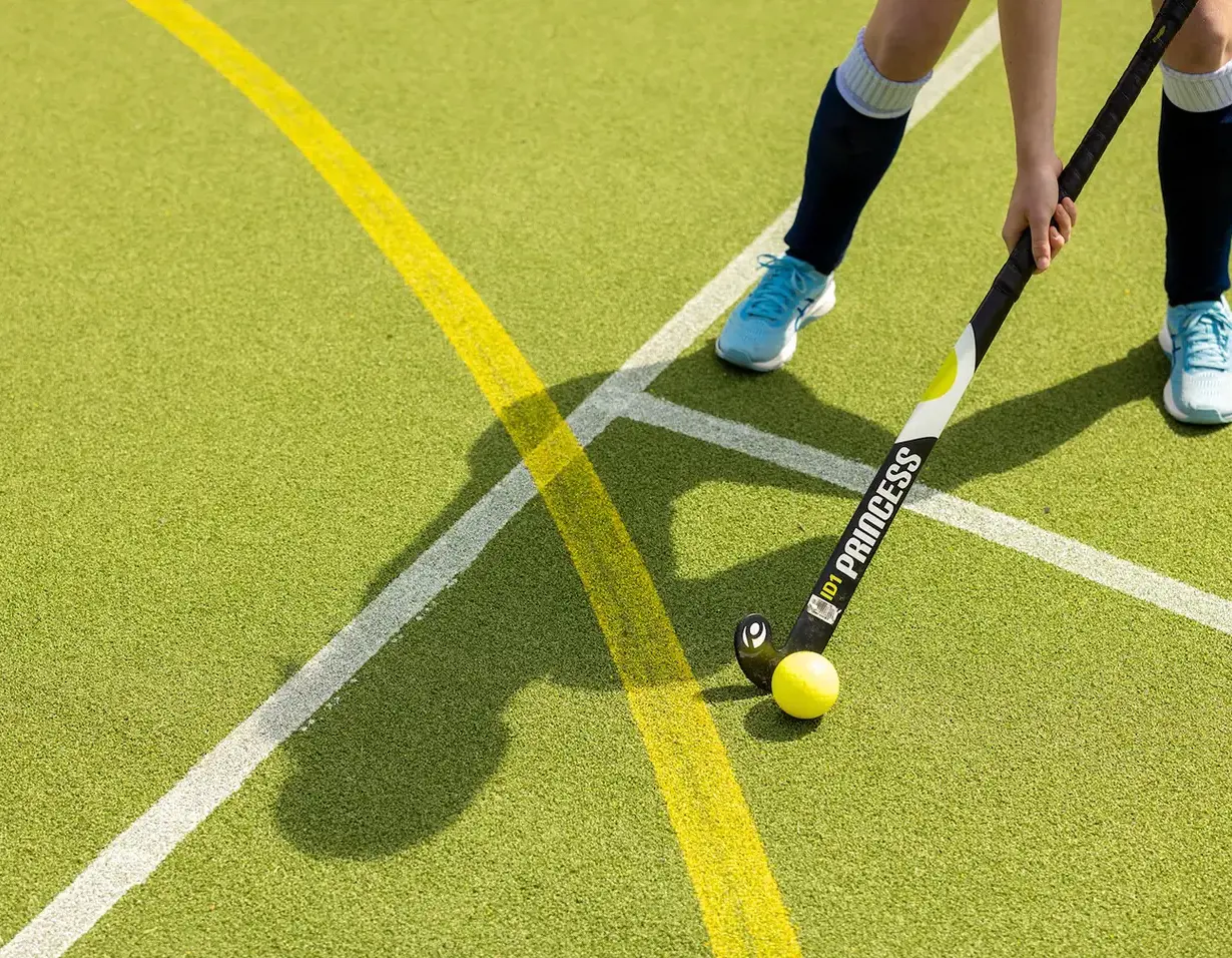 Sixth form hockey players doing a warm up at Ibstock Place School, a private school near Richmond, Barnes, Putney, Kingston, and Wandsworth