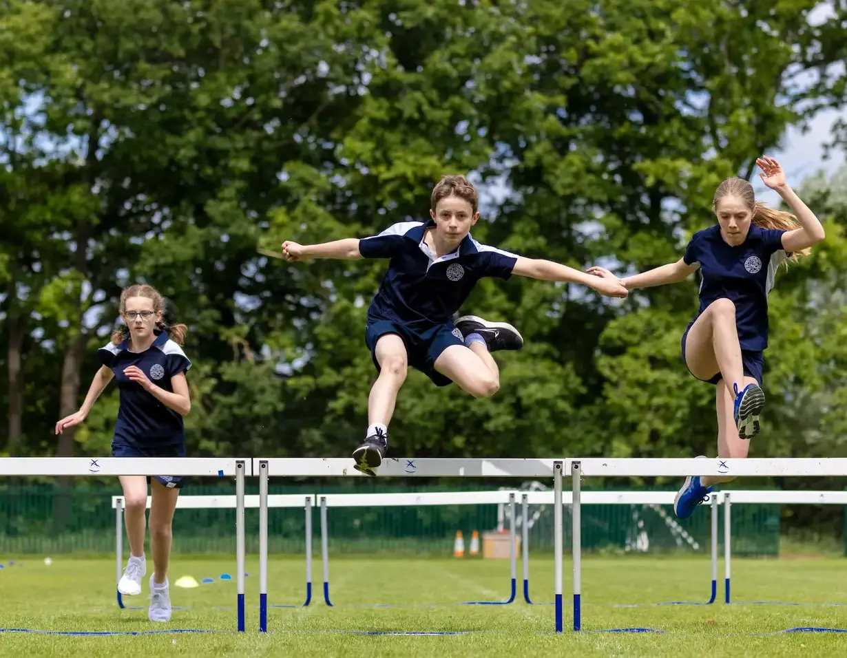 Welcome to Ibstock Place School, a leading private school in South-West London, Near Richmond, Barnes, Putney, Kingston, & Wandsworth for children ages 4-18 years. Senior pupils doing a hurdle race at Ibstock Place School, a private school near Richmond, Barnes, Putney, Kingston, and Wandsworth.