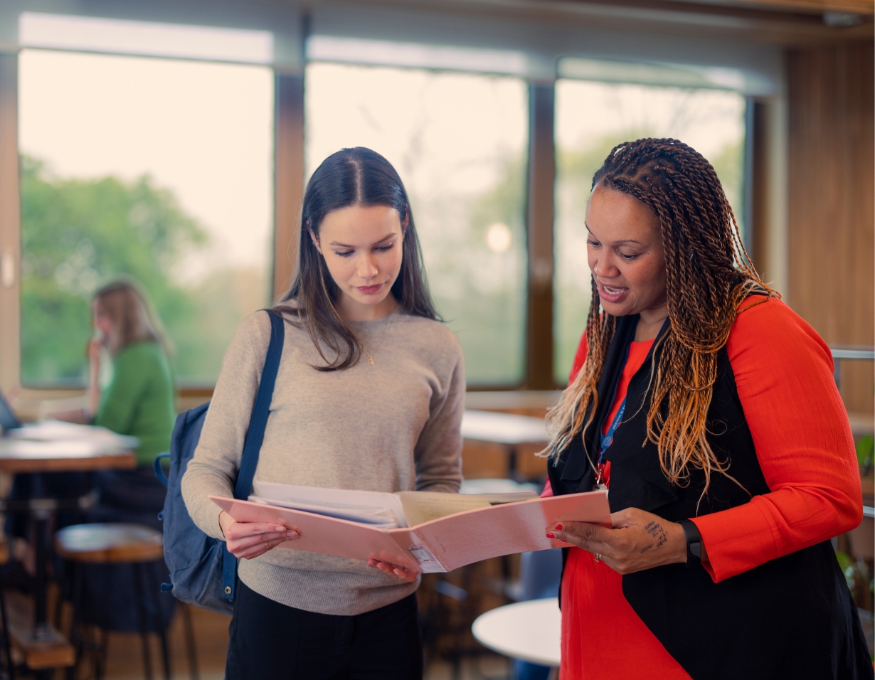 Teacher helping our a Sixth form pupil at Ibstock Place School, a private school near Richmond, Barnes, Putney, Kingston, and Wandsworth.