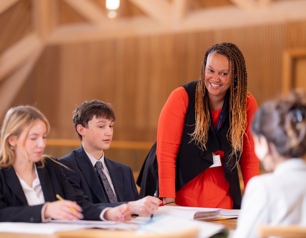 Sixth form pupils studying in the Great hall with a teacher at Ibstock Place School, a private school near Richmond, Barnes, Putney, Kingston, and Wandsworth.