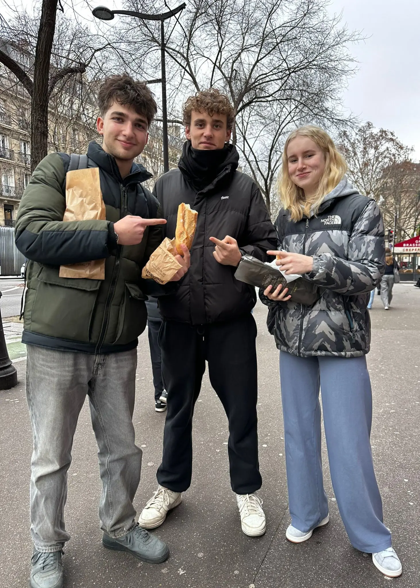 Sixth Form pupils in Paris holding bread | Ibstock Place School, Roehampton, Private School Near Richmond, Barnes, Putney, Kingston, & Wandsworth 